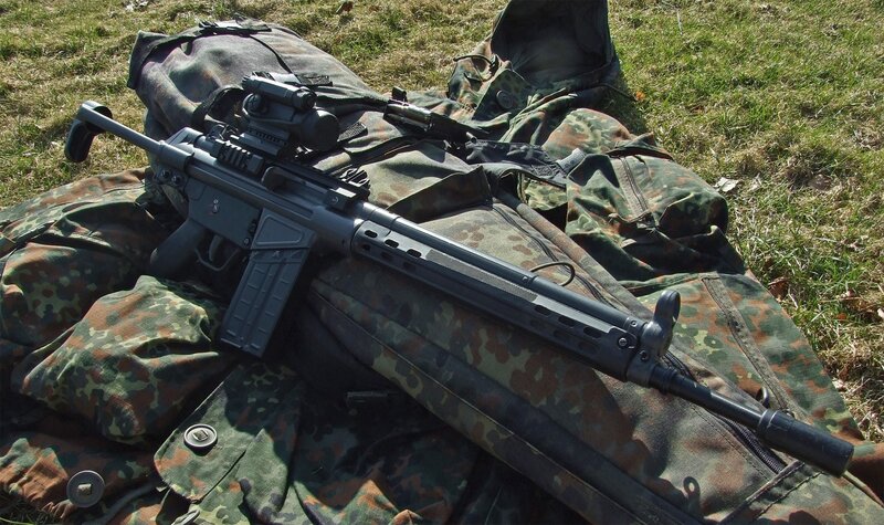 Assault rifle on camouflage gear
