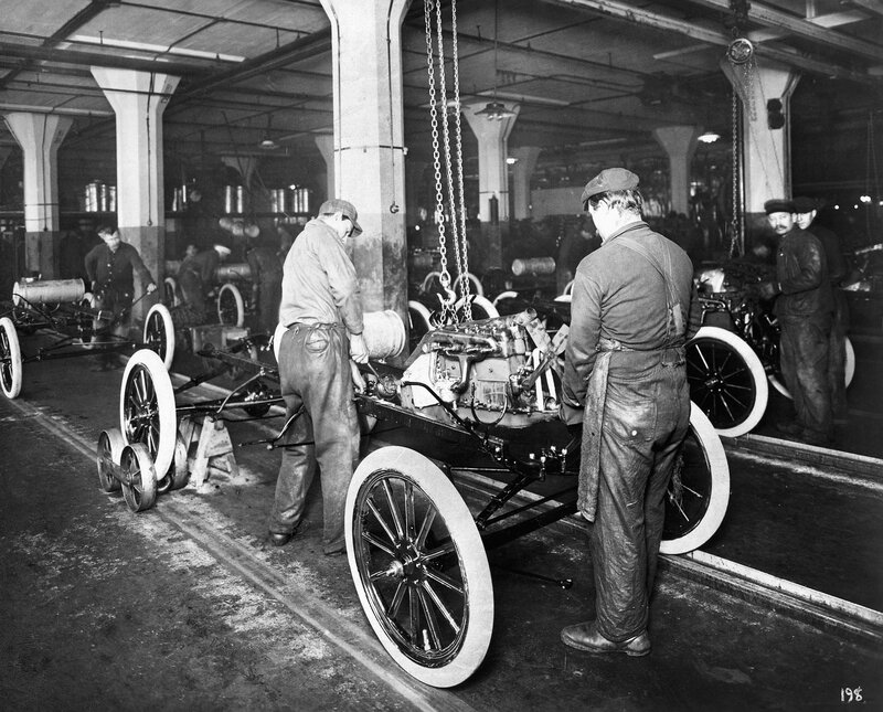 Assembly line at early car factory