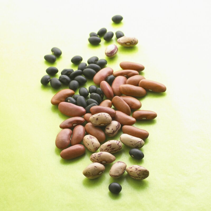 assorted beans on green surface