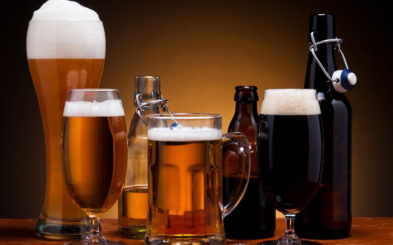Assorted beers in glasses and bottles