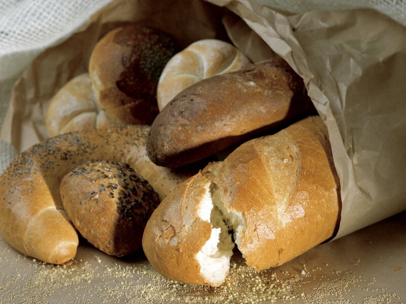 Assorted breads in a paper bag