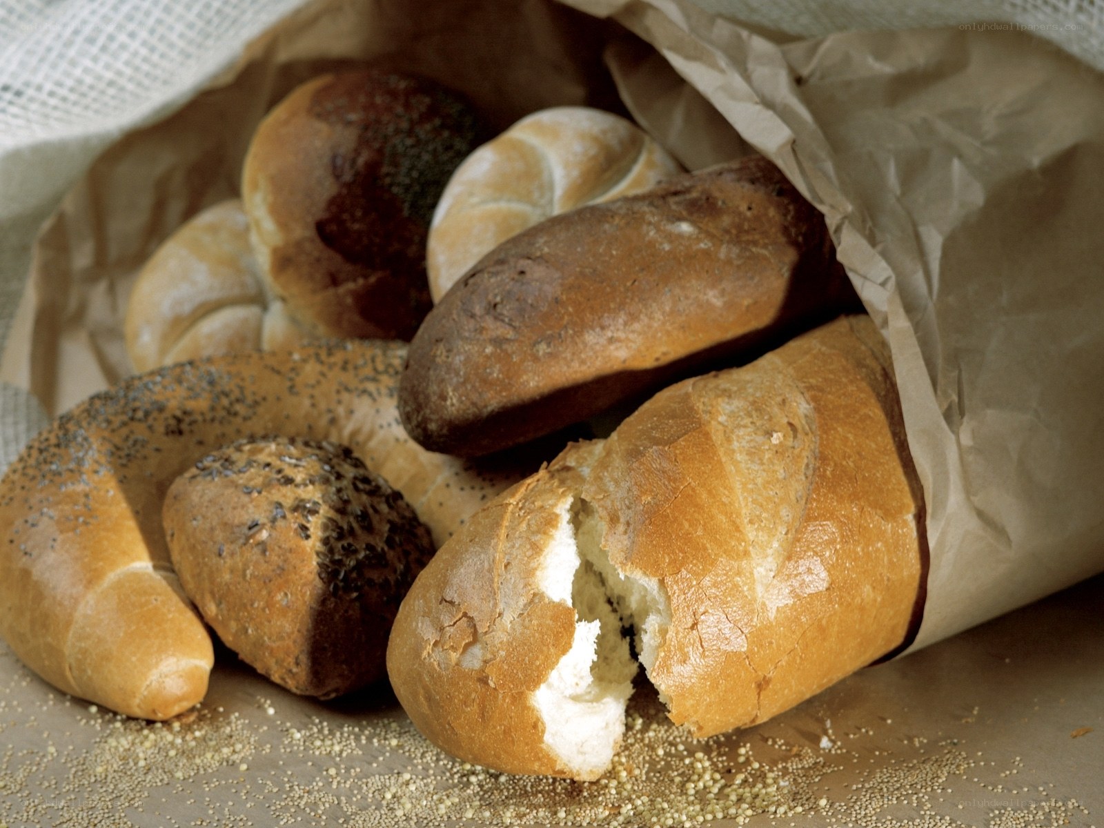 Assorted breads in a paper bag