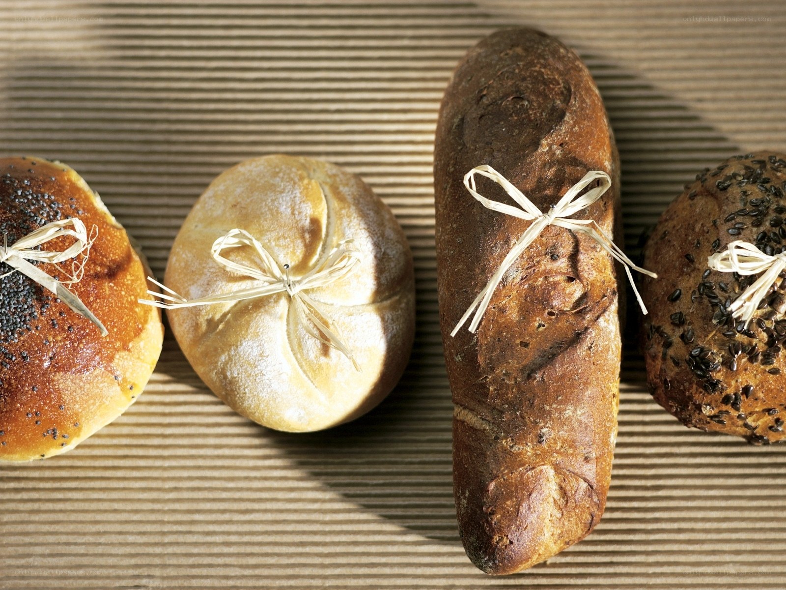 Assorted breads on a wooden surface
