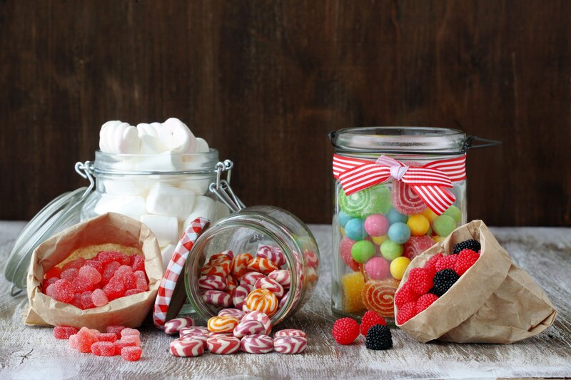Assorted candies in jars and bags