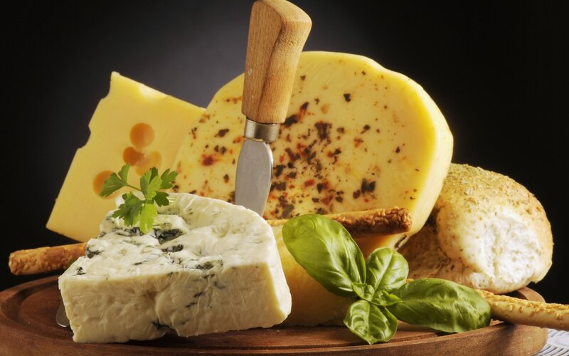 Assorted Cheeses on Board — Yellow, Dramatic, Photograph
