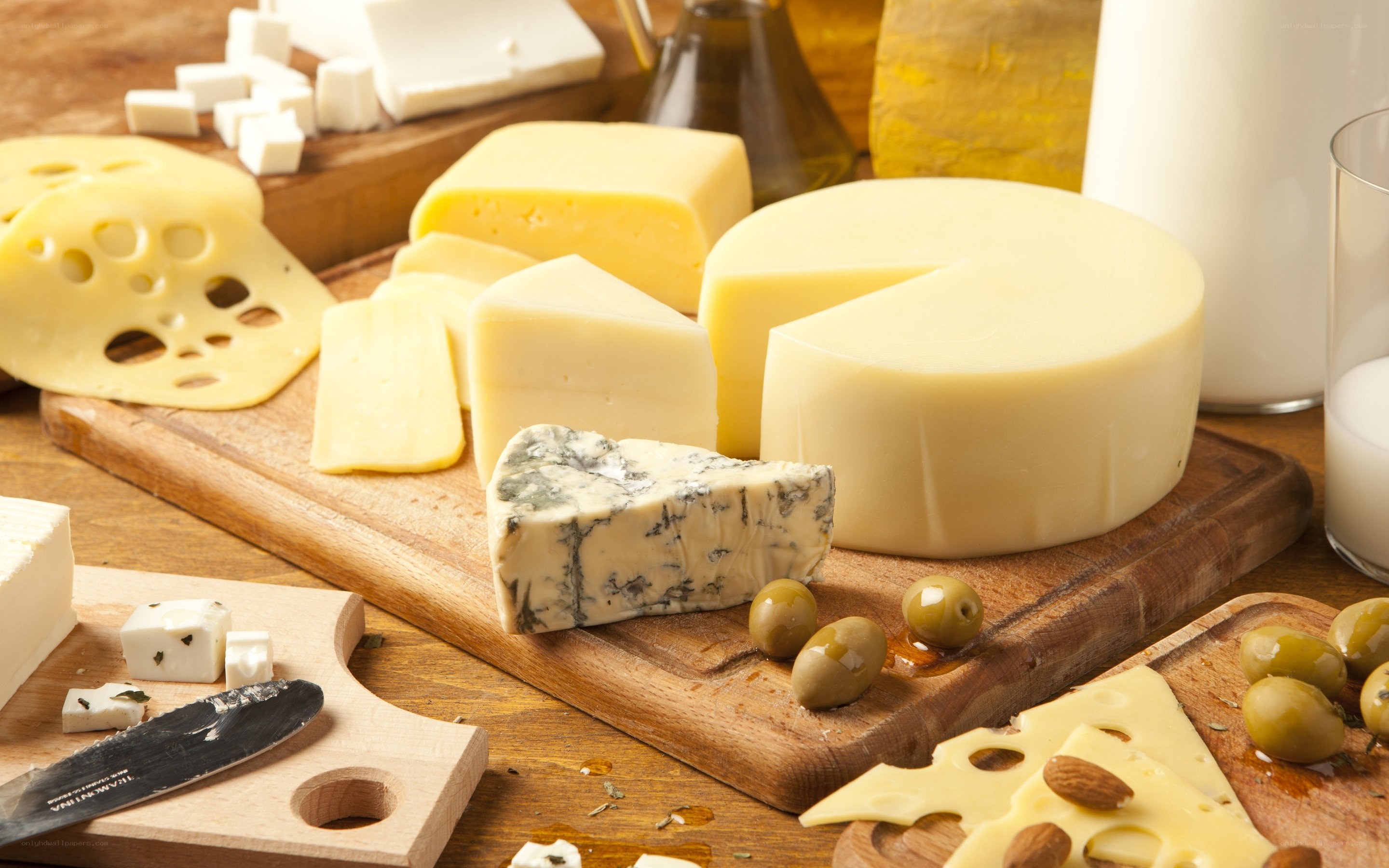 assorted cheeses on wooden board