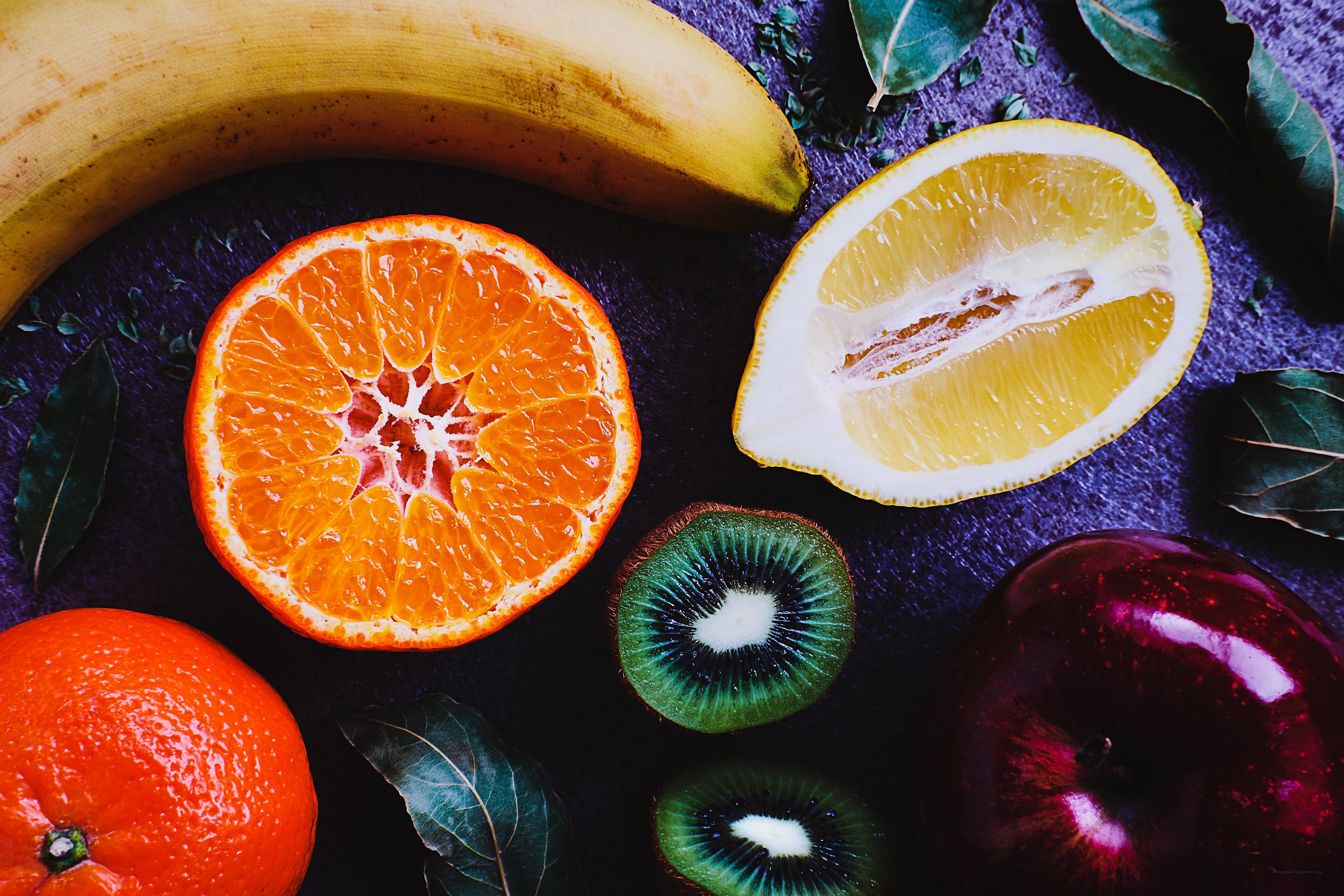 Assorted fresh fruits on dark surface