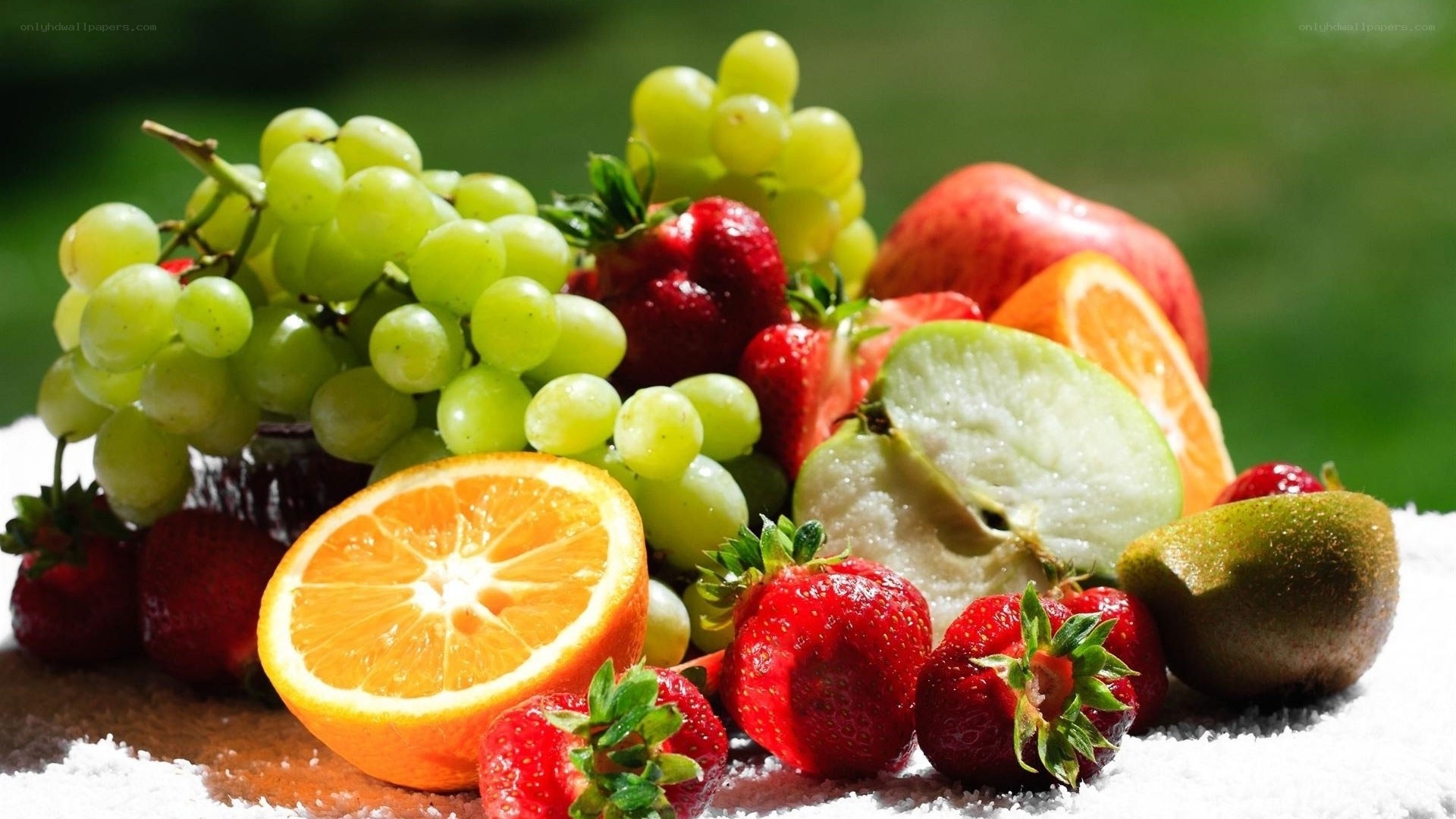 Assorted fresh fruits on white cloth