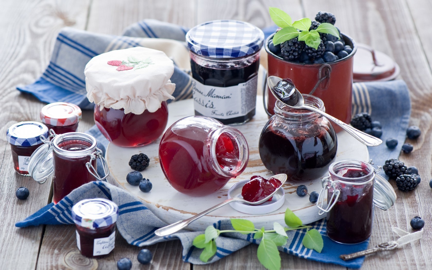 Assorted fruit jams on wooden table