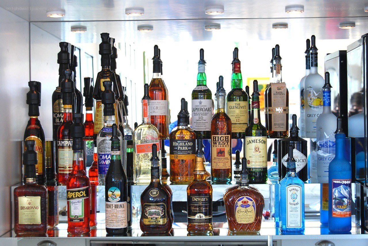Assorted liquor bottles on a bar