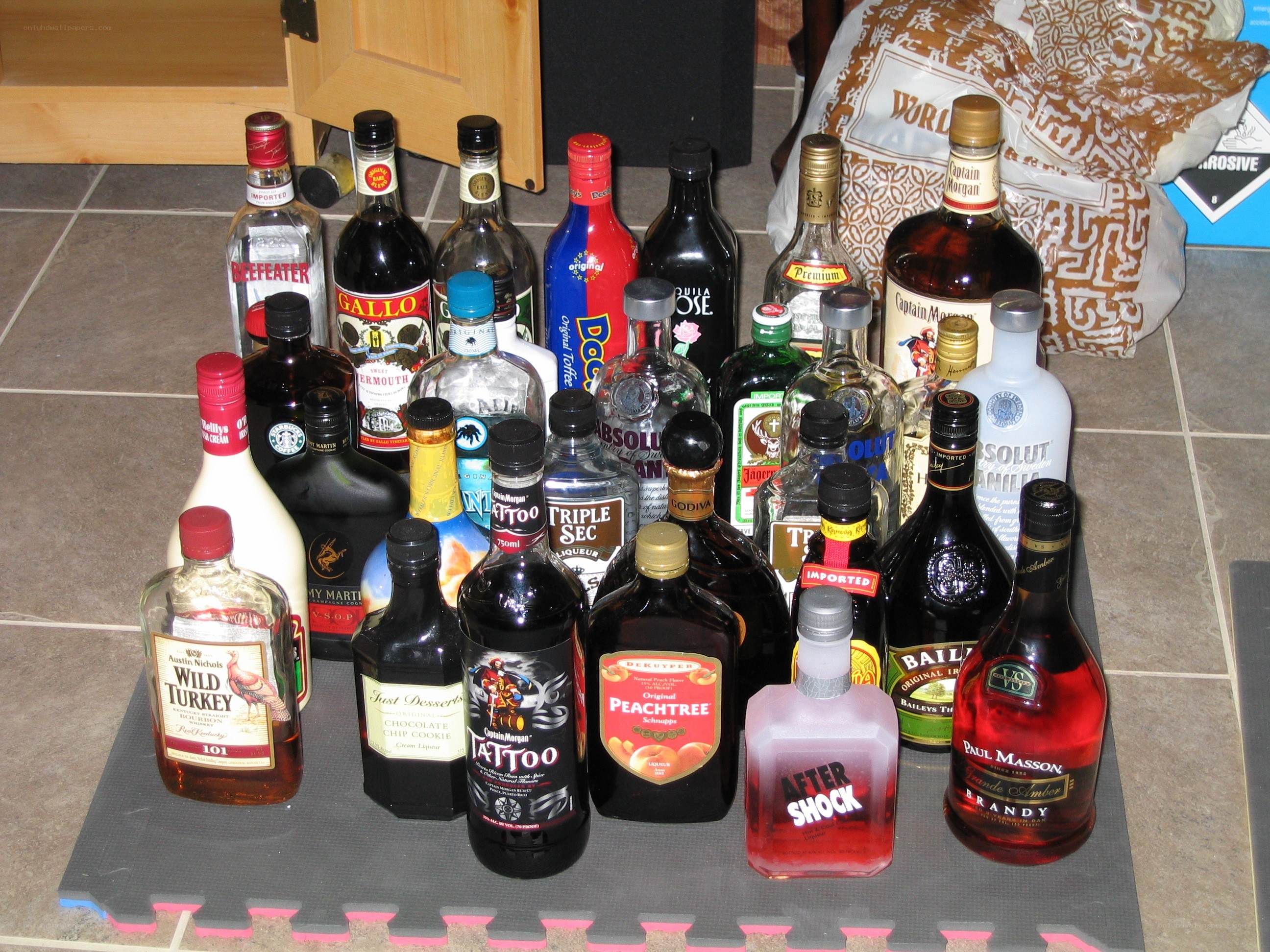 assorted liquor bottles on floor