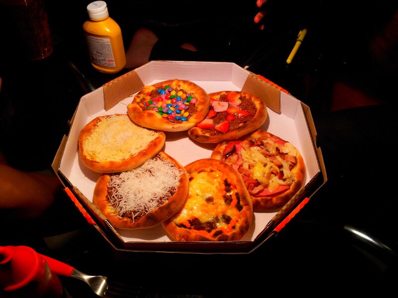 Assorted mini pizzas in a box