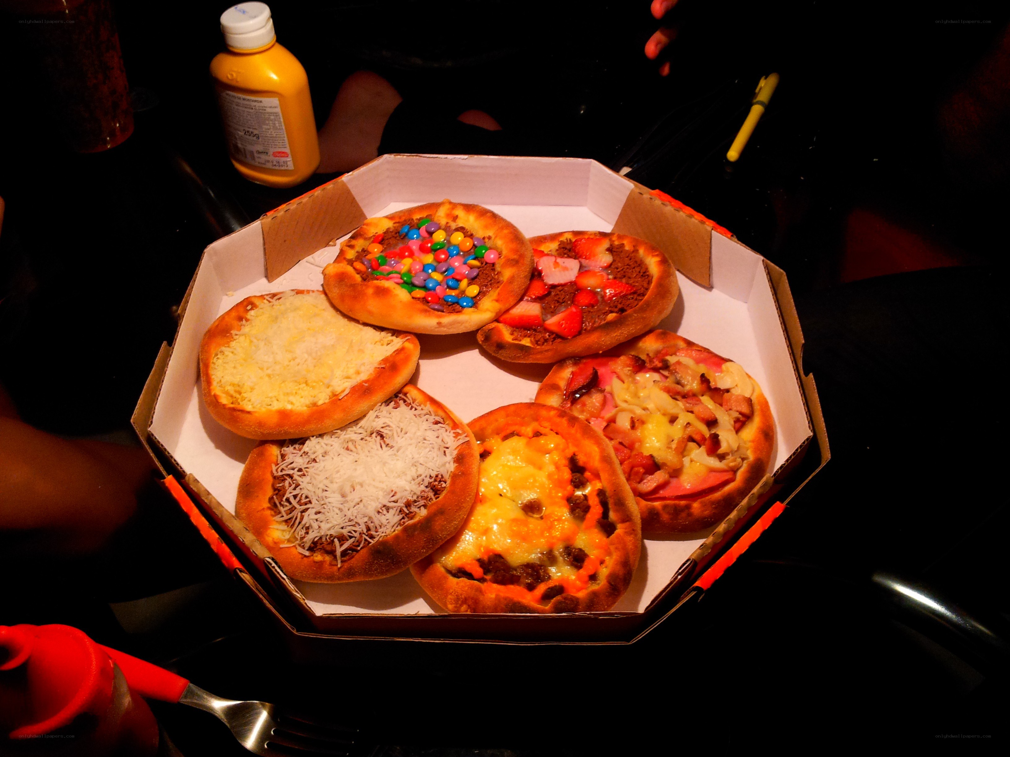 Assorted mini pizzas in a box