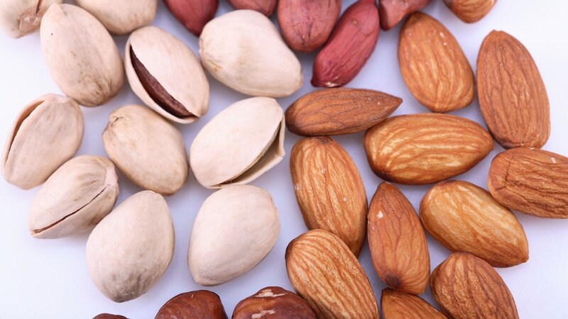 assorted nuts on white surface