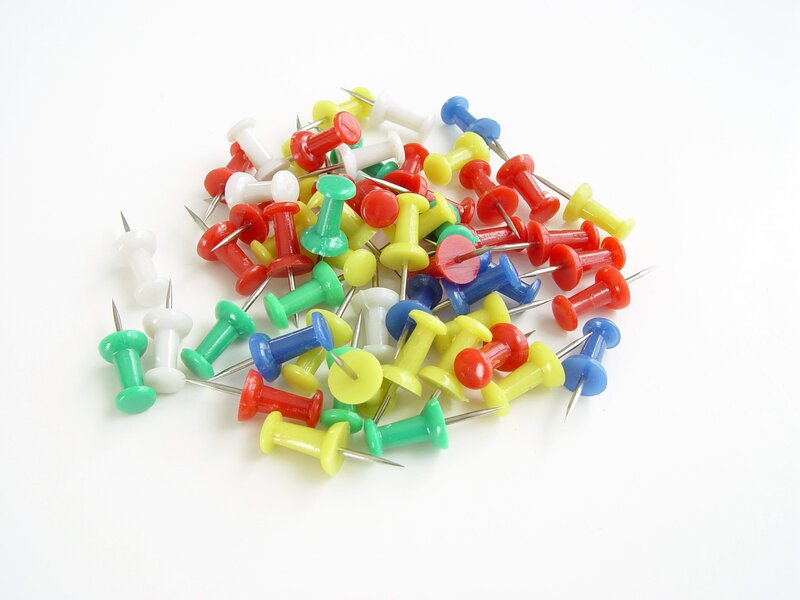 assorted push pins on white