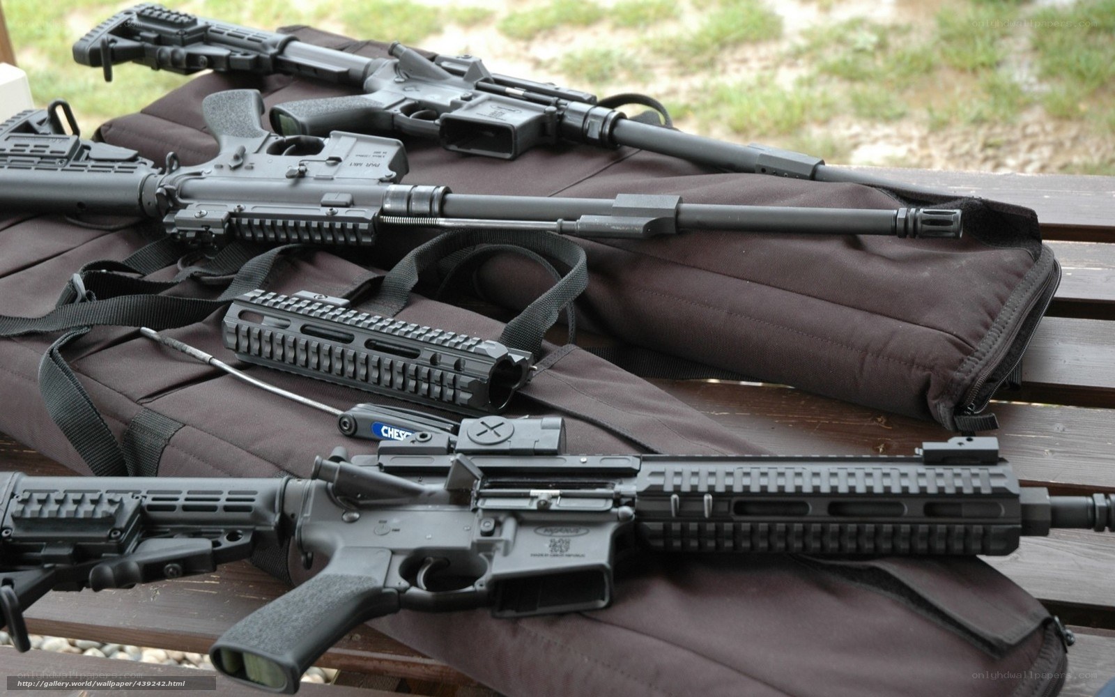 Assorted rifles on a bench