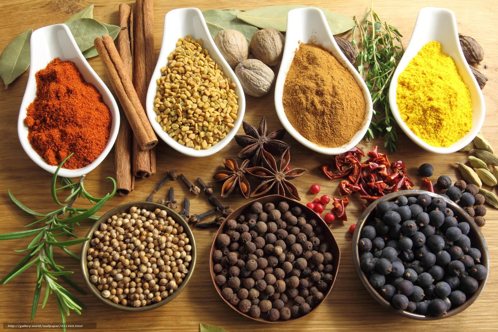 Assorted spices on wooden surface