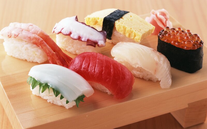 Assorted sushi on a wooden board