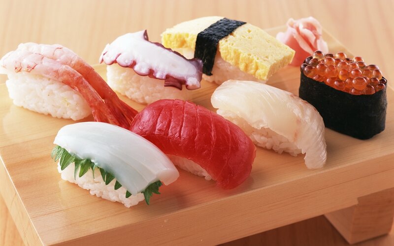 Assorted sushi on wooden board