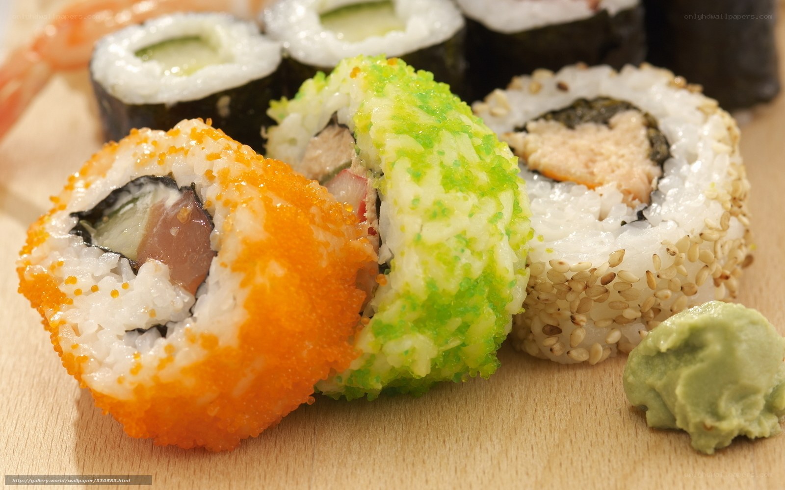Assorted sushi rolls on wood