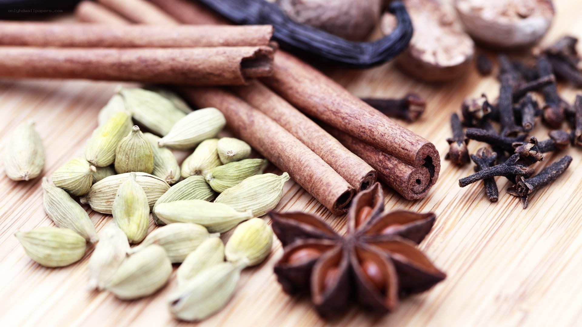 assorted whole spices on wood