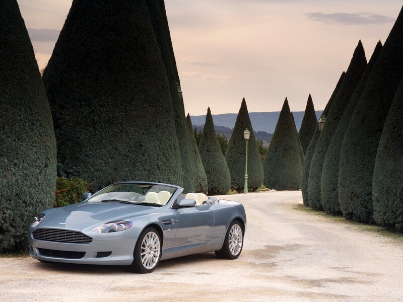 Aston Martin DB9 on a tree-lined path