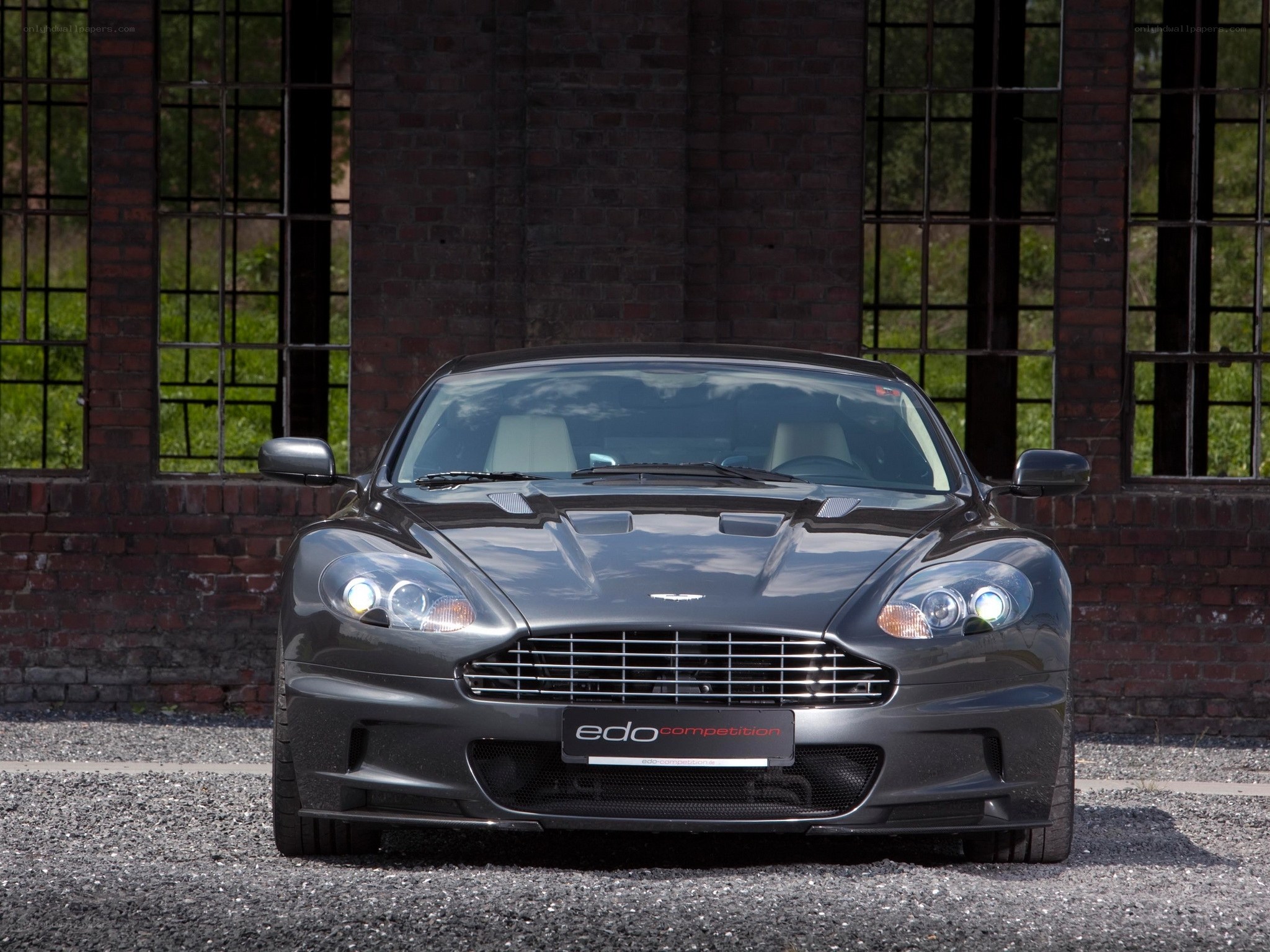 Aston Martin DBS in front of brick building
