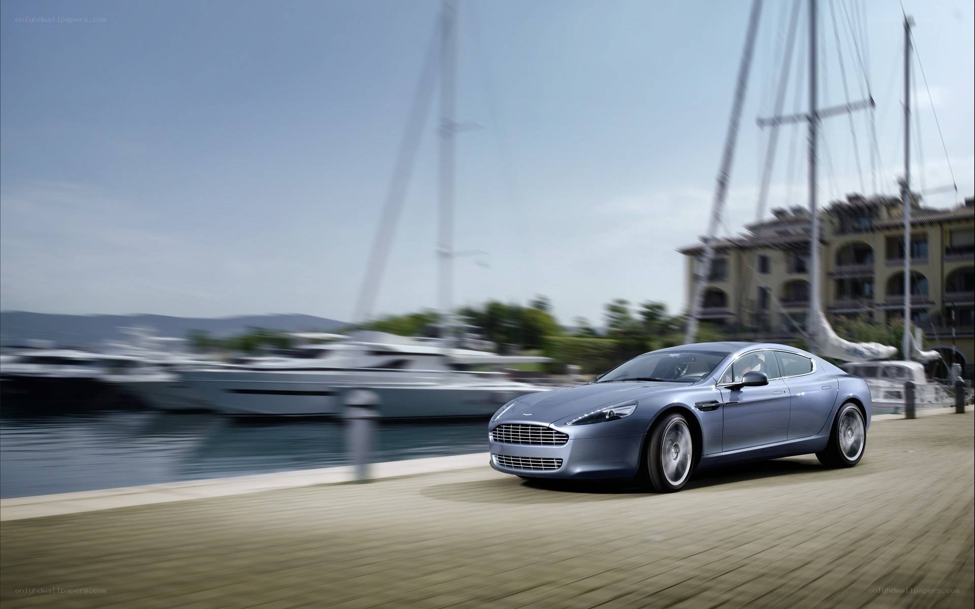 Aston Martin driving by a marina