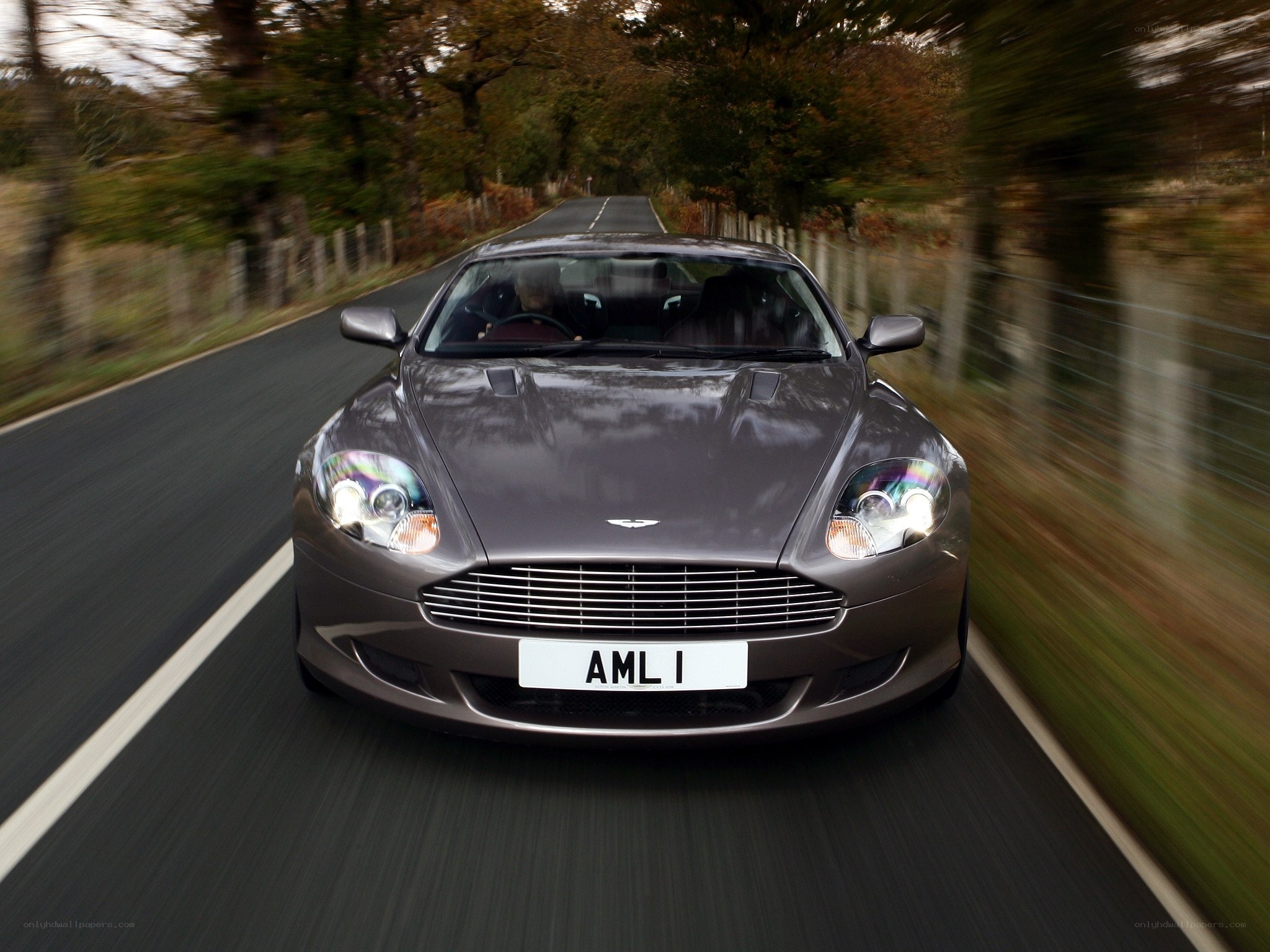 Aston Martin driving on a country road