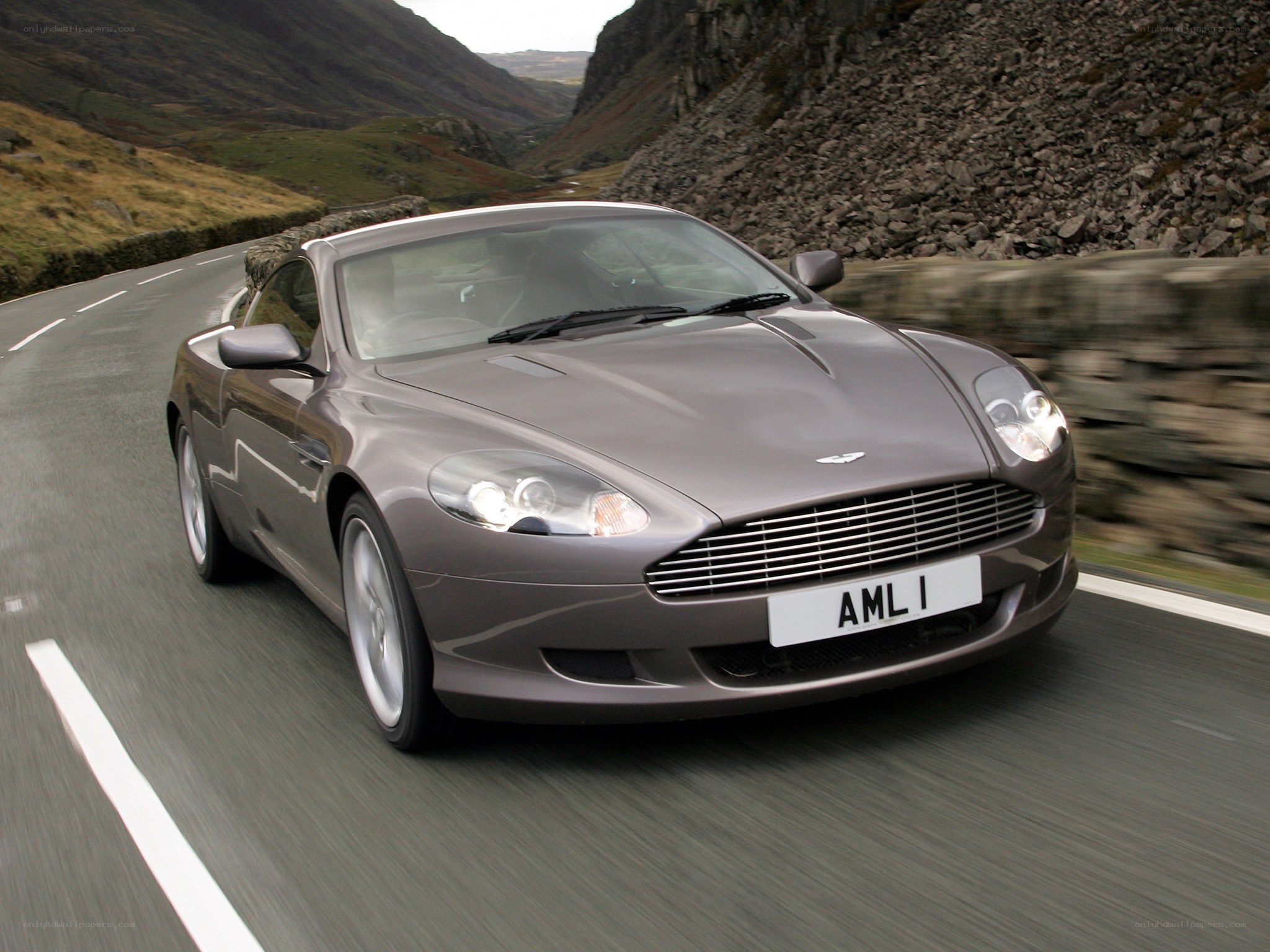 Aston Martin driving on a mountain road