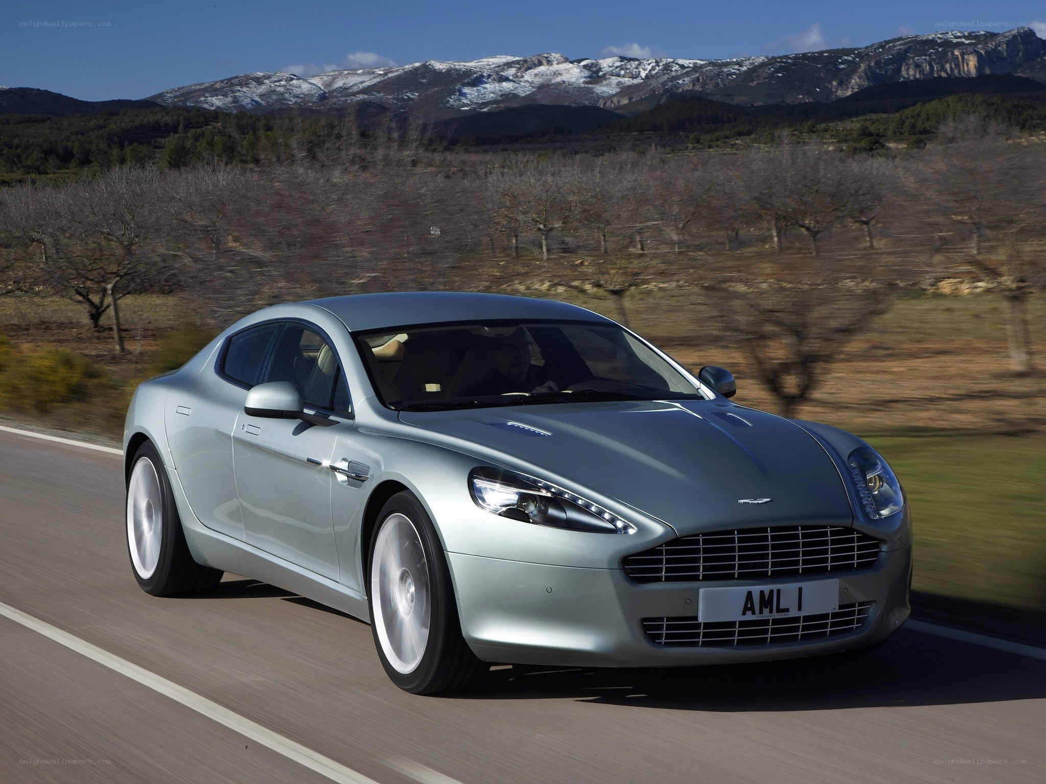 Aston Martin driving on a road