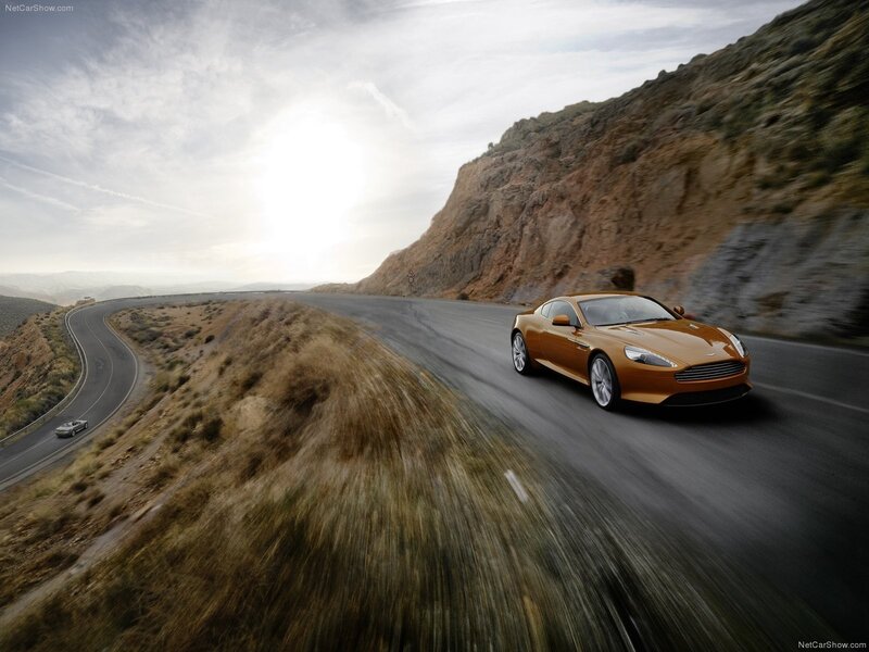 Aston Martin driving on a winding road