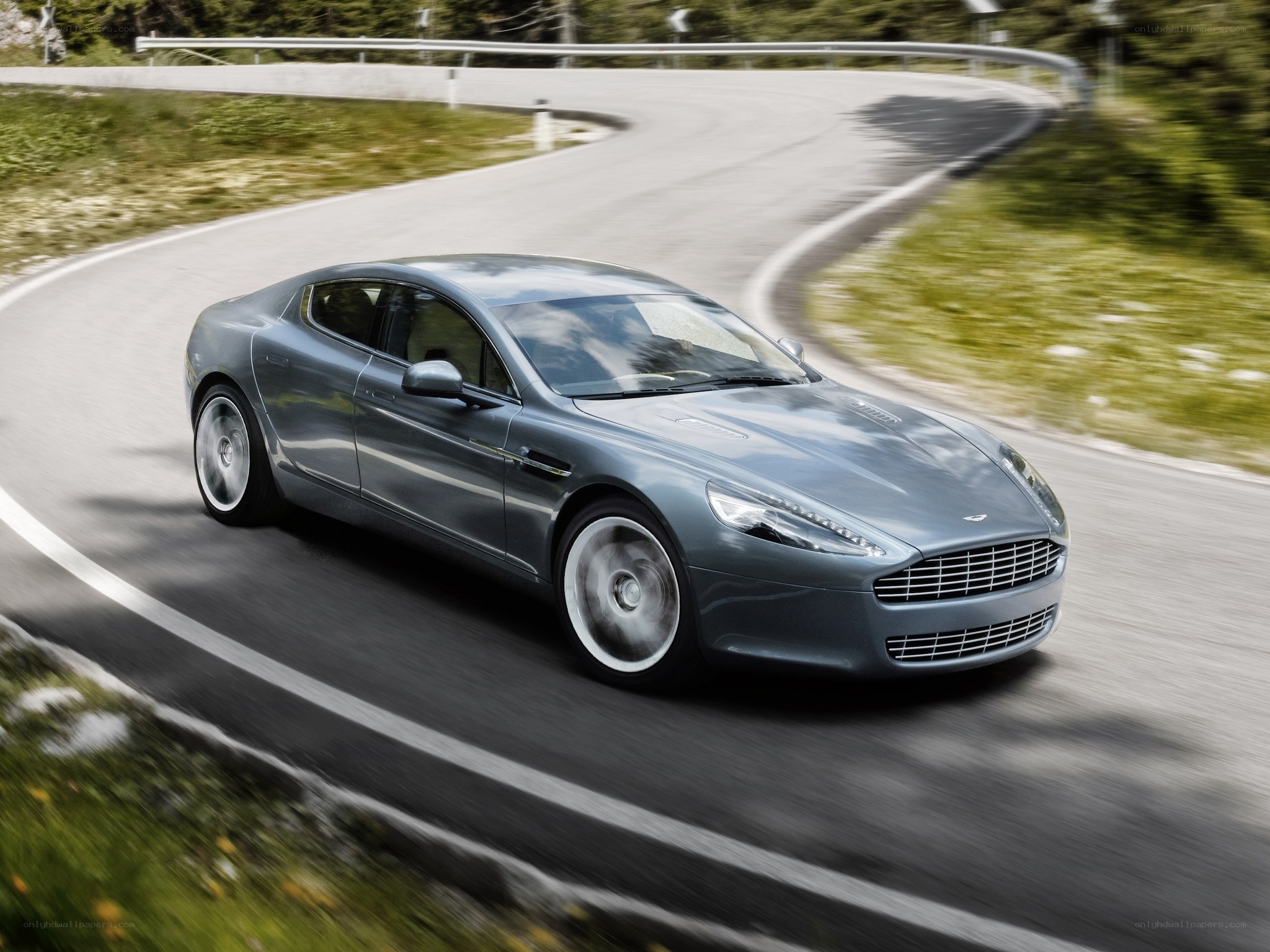 Aston Martin driving on a winding road