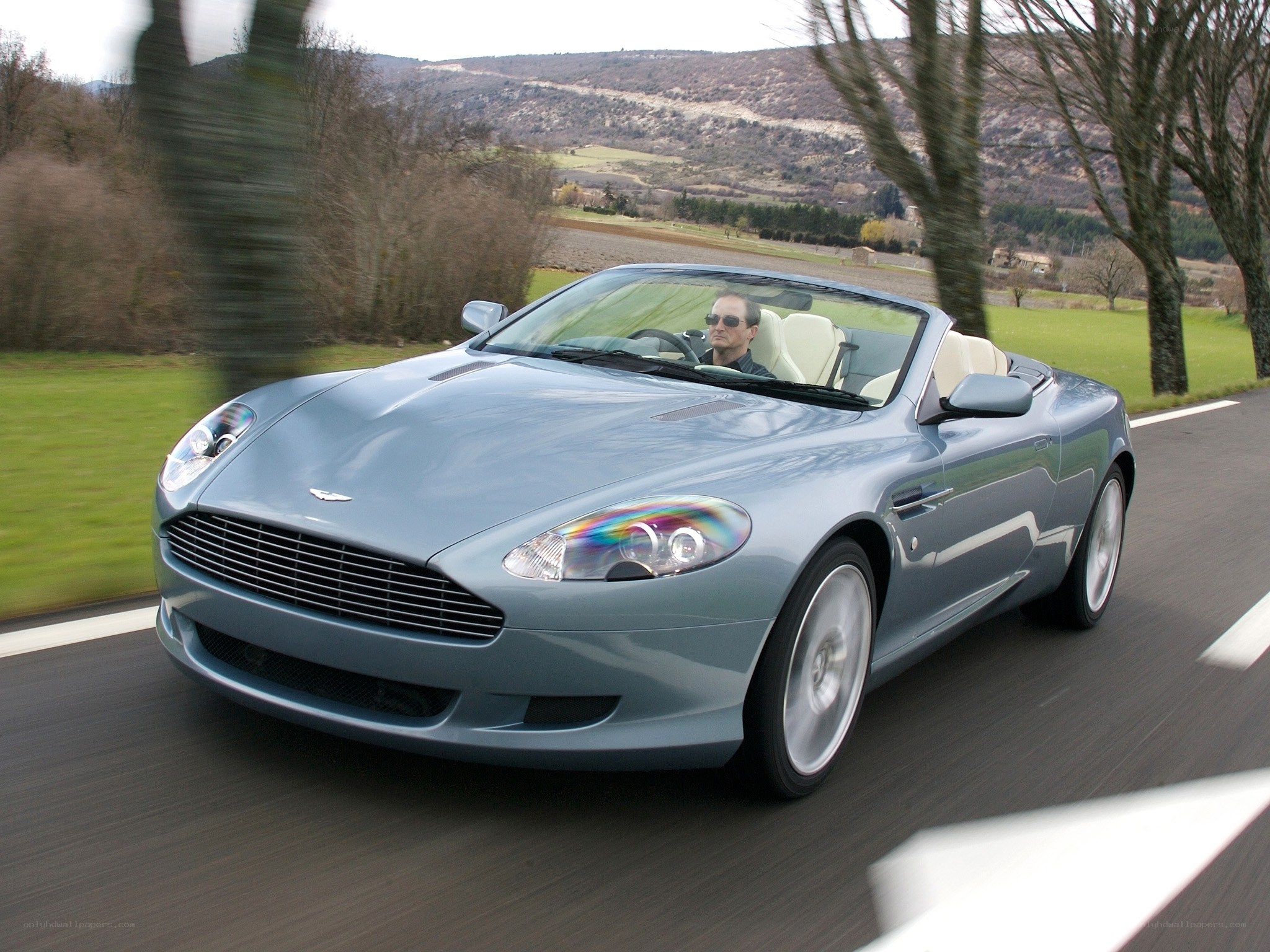Aston Martin driving on country road