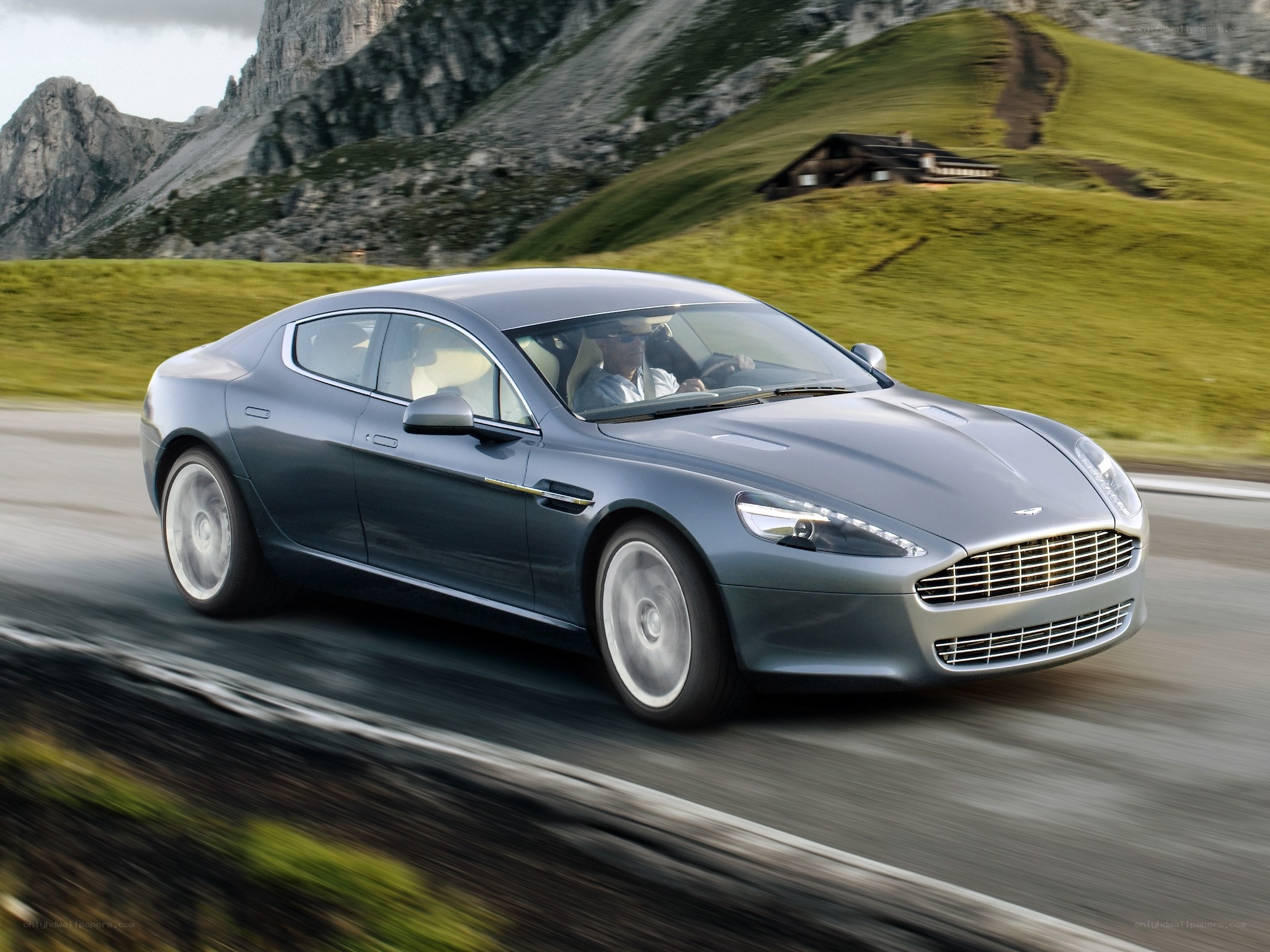 Aston Martin driving on mountain road