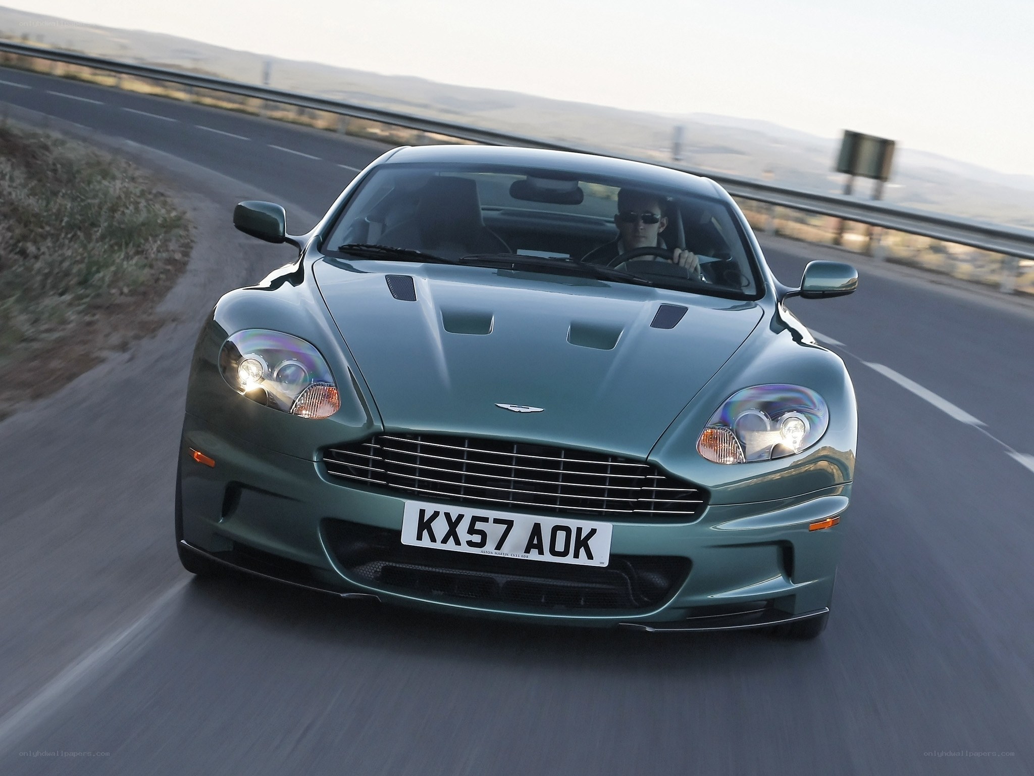 Aston Martin driving on road