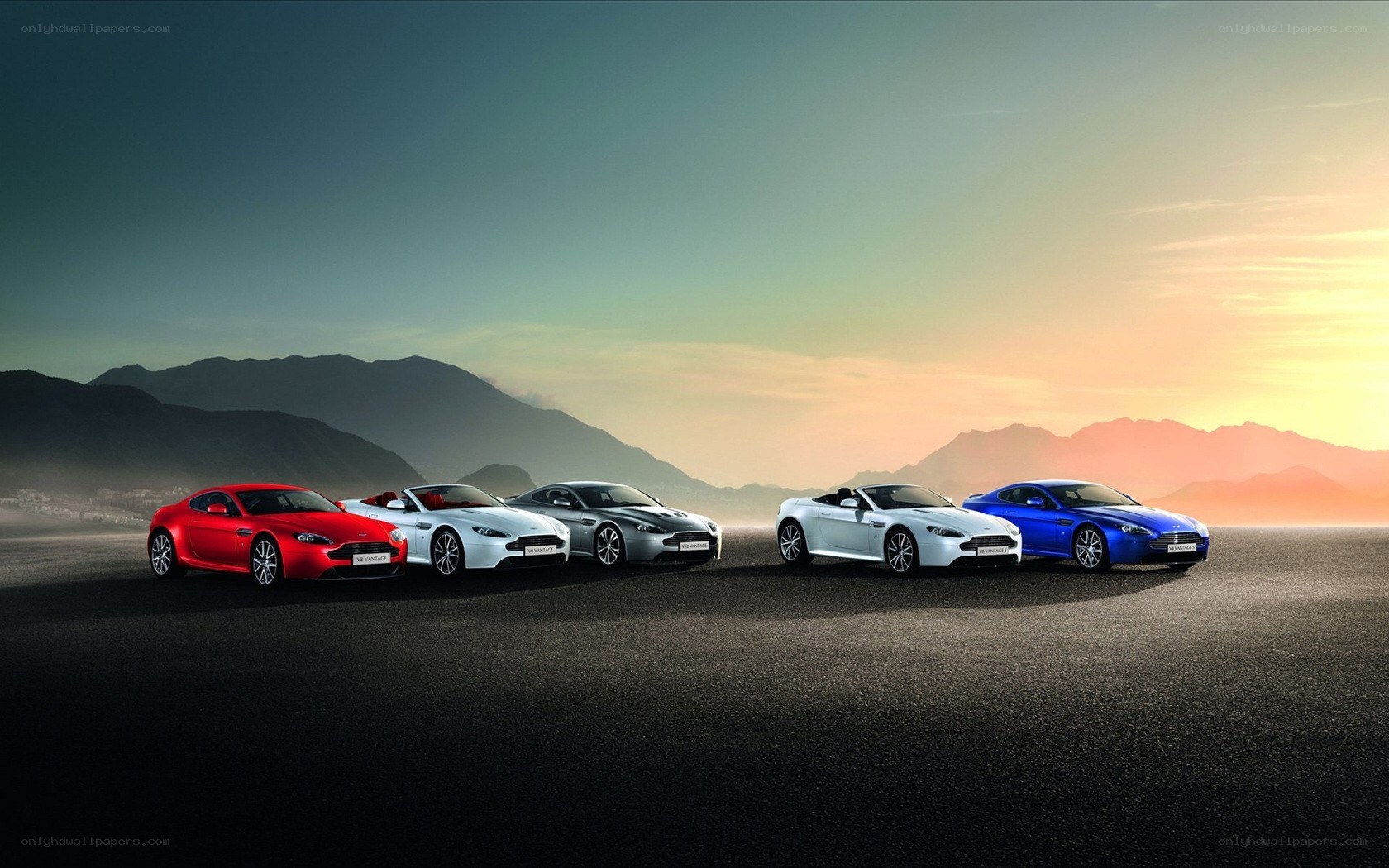 Aston Martin lineup at sunset