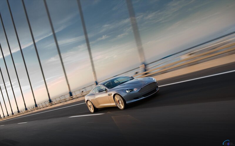 Aston Martin on a bridge at sunset