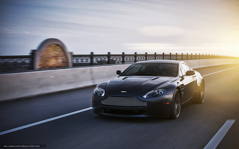 Aston Martin on a bridge at sunset