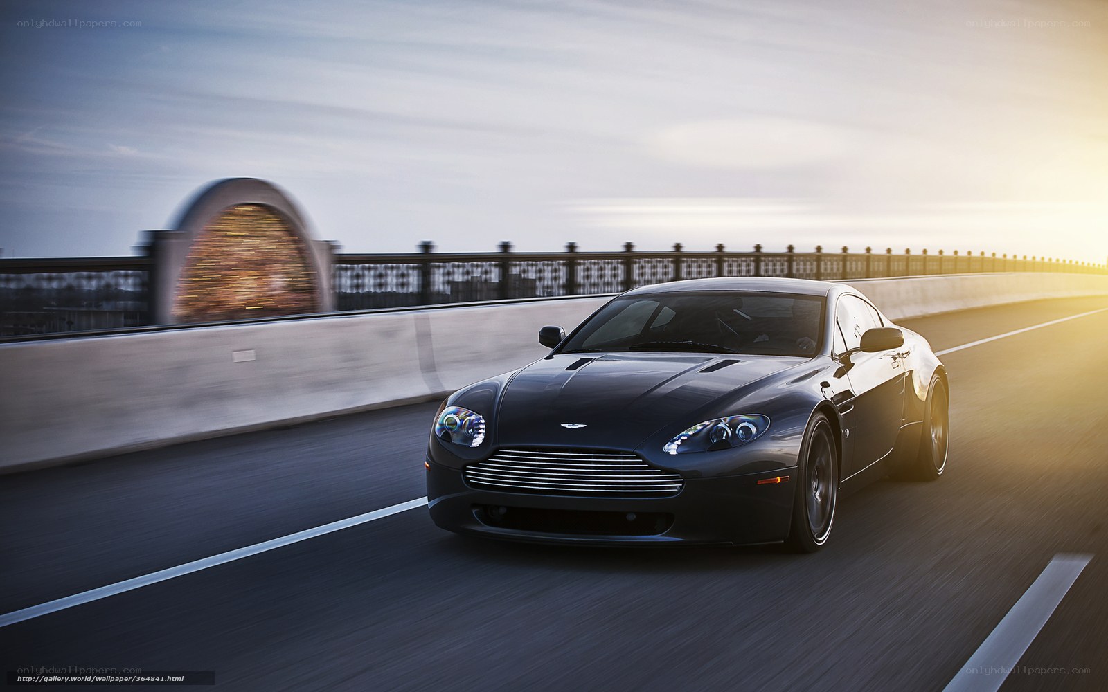 Aston Martin on a bridge at sunset