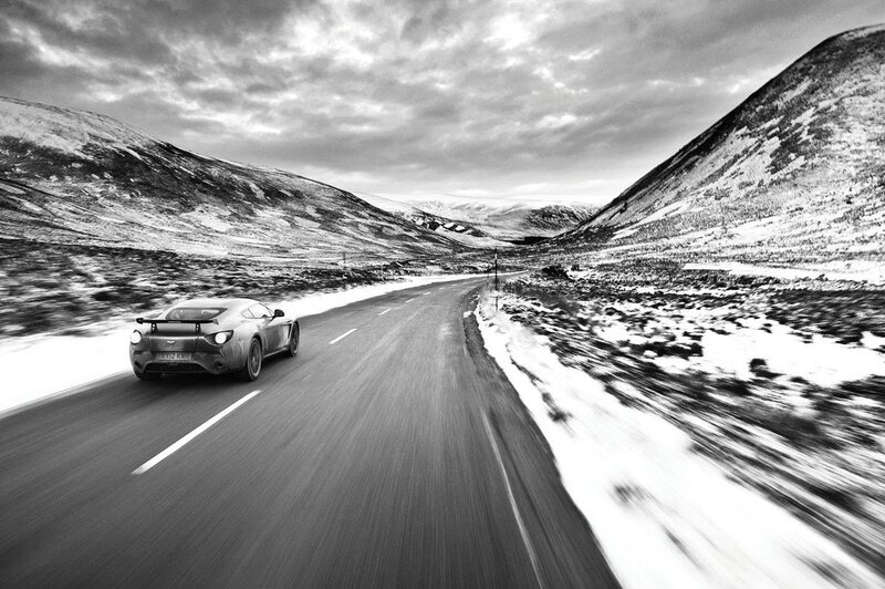 Aston Martin on a snowy mountain road