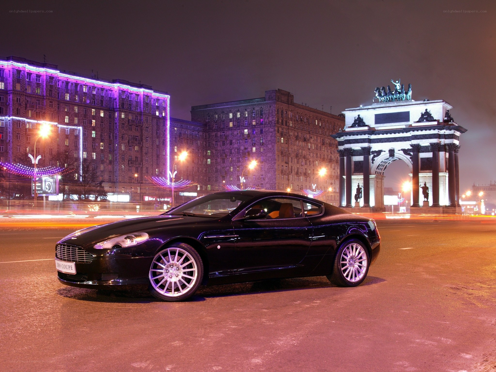 Aston Martin on city street at night