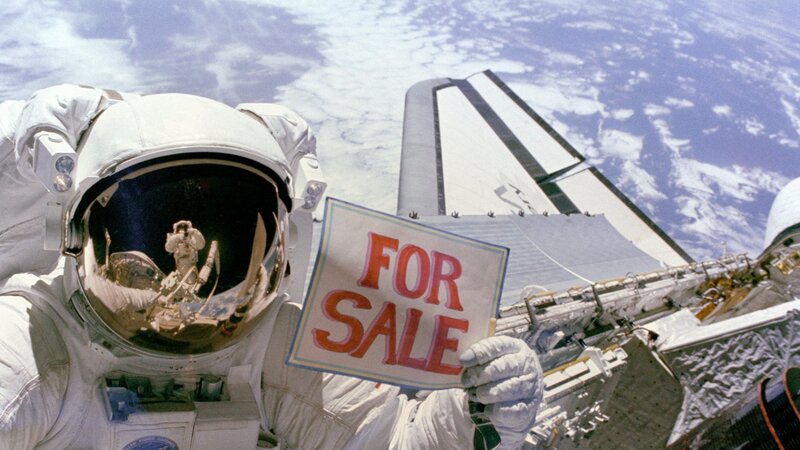 Astronaut holding for sale sign