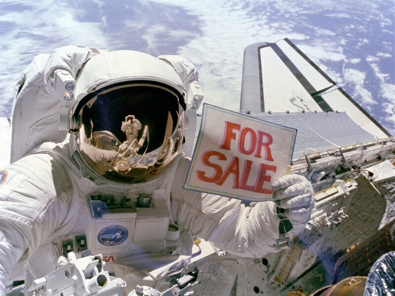 Astronaut holding for sale sign