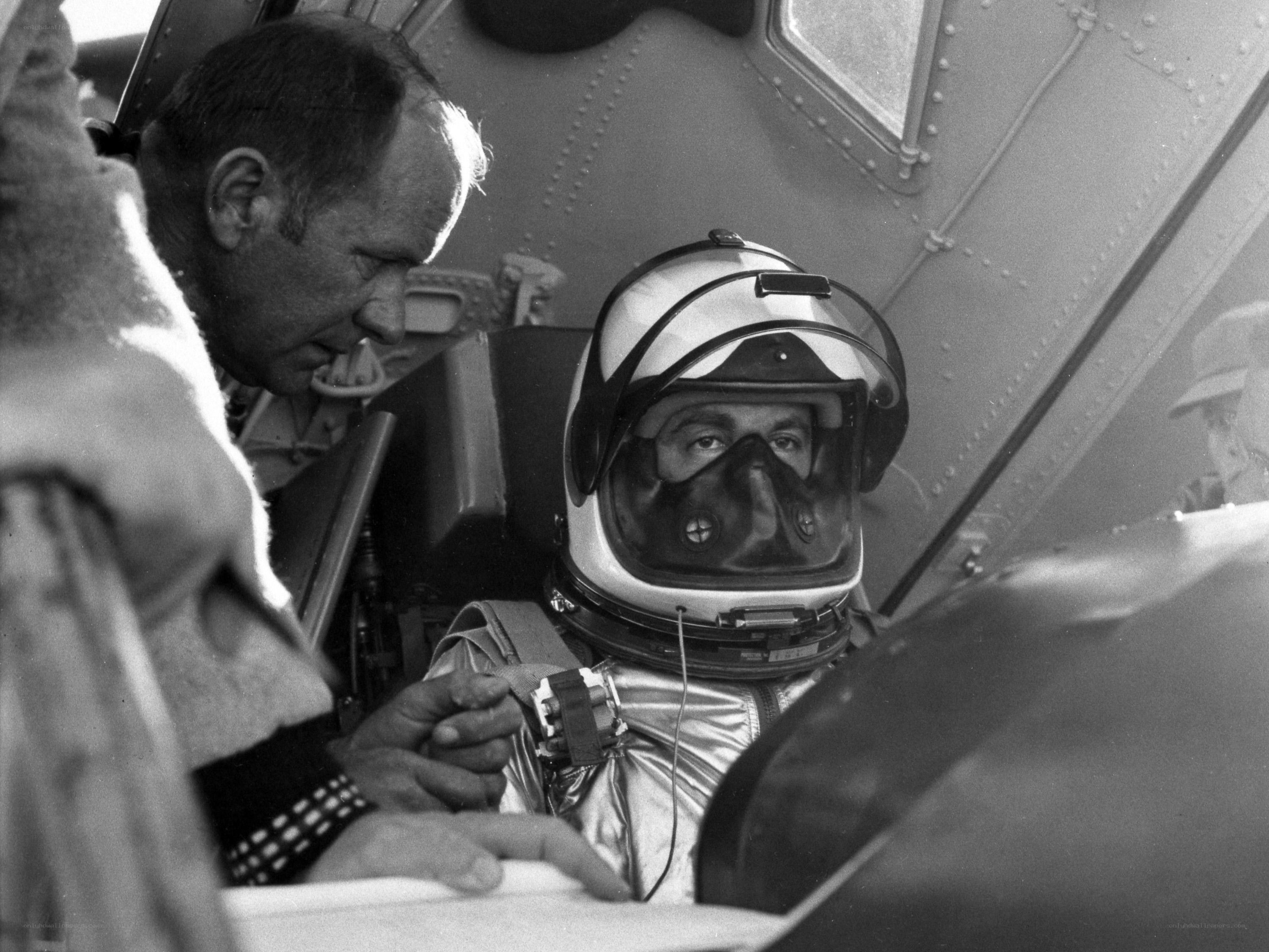 Astronaut in cockpit with technician