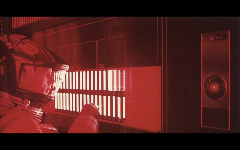 astronaut in red-lit cabin