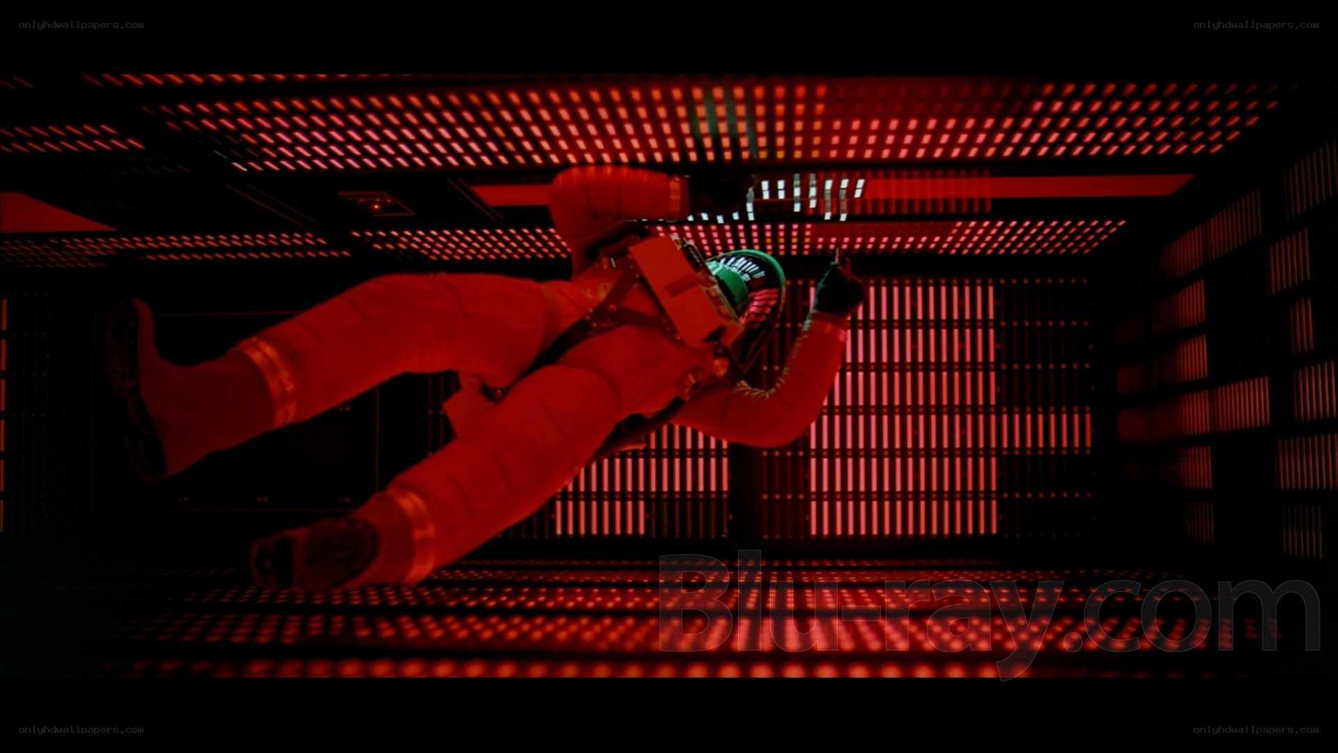 astronaut in red-lit chamber
