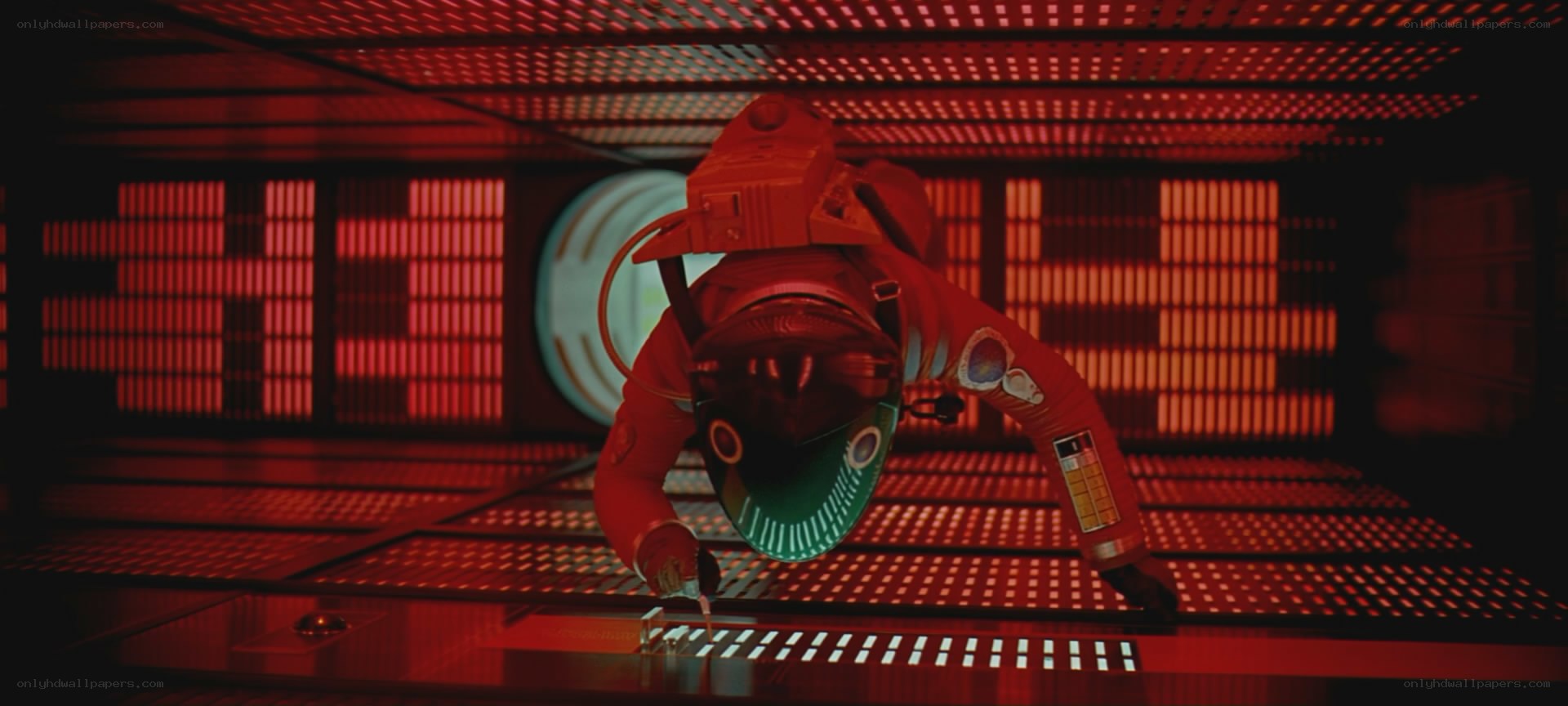 astronaut in red-lit chamber