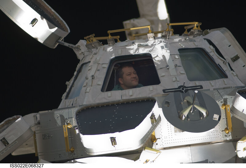 Astronaut in space station module