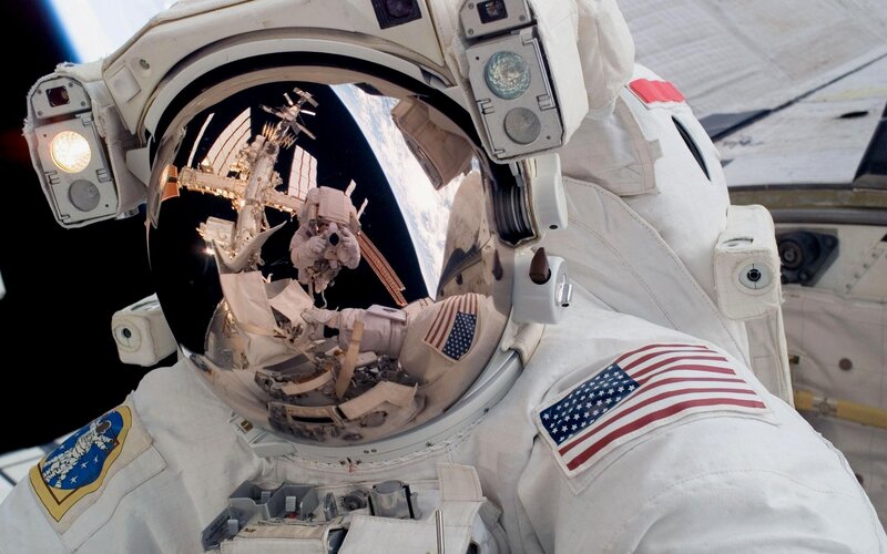Astronaut in Space Suit — White, Dramatic, Photograph, Space Station, Earth, American Flag
